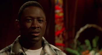 Movie still from “Tales from the Hood” (1995), directed by Rusty Cundieff – A person wearing a plaid shirt; Close Up shot, Low angle