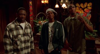 Movie still from “Tales from the Hood” (1995), directed by Rusty Cundieff – A group of young men standing next to each other in a room; Medium shot, Low angle