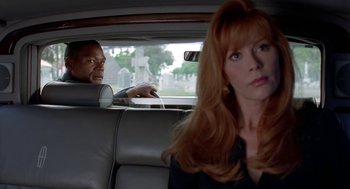 Movie still from “Tales from the Hood” (1995), directed by Rusty Cundieff – Two people sitting in a car in the back of a car; Medium shot, Over the shoulder angle