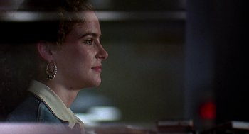 Movie still from “Talk Radio” (1988), directed by Oliver Stone – A person with short brown hair; Close Up shot, Over the shoulder angle