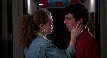 Movie still from “Talk Radio” (1988), directed by Oliver Stone – A man and a woman are touching their necks together; Close Up shot, Over the shoulder angle