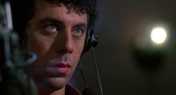 Movie still from “Talk Radio” (1988), directed by Oliver Stone – A person wearing a headset; Close Up shot, Low angle