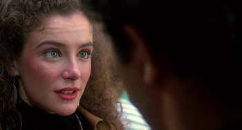 Movie still from “Talk Radio” (1988), directed by Oliver Stone – A woman's face with a man looking on; Close Up shot, Over the shoulder angle