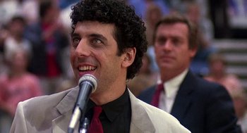 Movie still from “Talk Radio” (1988), directed by Oliver Stone – A person with a microphone; Close Up shot, Low angle