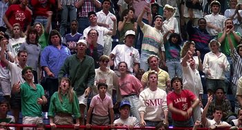 Movie still from “Talk Radio” (1988), directed by Oliver Stone – A group of people standing in the stands at a baseball game; Wide shot, High angle
