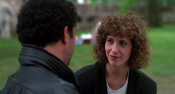 Movie still from “Talk Radio” (1988), directed by Oliver Stone – A man and a woman talking to each other outside; Close Up shot, Over the shoulder angle