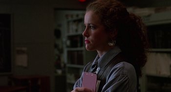 Movie still from “Talk Radio” (1988), directed by Oliver Stone – A woman holding a clipboard in her hands; Close Up shot, Over the shoulder angle