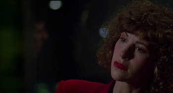 Movie still from “Talk Radio” (1988), directed by Oliver Stone – A person wearing a red jacket; Close Up shot, Over the shoulder angle