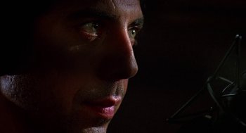 Movie still from “Talk Radio” (1988), directed by Oliver Stone – A man's face in the dark; Extreme Close Up shot, Low angle