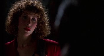 Movie still from “Talk Radio” (1988), directed by Oliver Stone – A person wearing a red jacket; Close Up shot, Over the shoulder angle