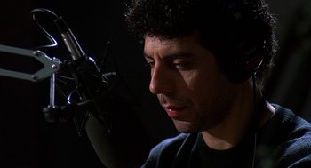 Movie still from “Talk Radio” (1988), directed by Oliver Stone – A person with a microphone; Close Up shot, Low angle