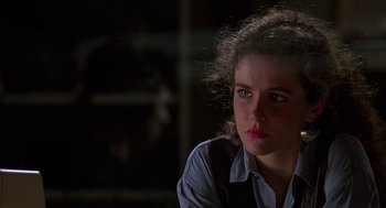 Movie still from “Talk Radio” (1988), directed by Oliver Stone – A young woman sitting in front of a window; Close Up shot, Over the shoulder angle