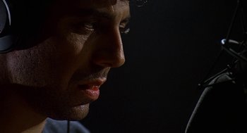 Movie still from “Talk Radio” (1988), directed by Oliver Stone – A man's face in the dark; Extreme Close Up shot, Low angle