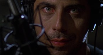 Movie still from “Talk Radio” (1988), directed by Oliver Stone – A man's face with wires in the background; Extreme Close Up shot, Low angle