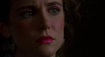 Movie still from “Talk Radio” (1988), directed by Oliver Stone – A woman's face in the dark; Close Up shot, Over the shoulder angle