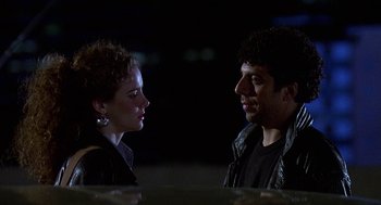 Movie still from “Talk Radio” (1988), directed by Oliver Stone – A man and a woman standing next to each other in the dark; Close Up shot, Low angle