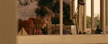 Movie still from “Tamara Drewe” (2010), directed by Stephen Frears – An older man looking out of a window; Close Up shot, Low angle
