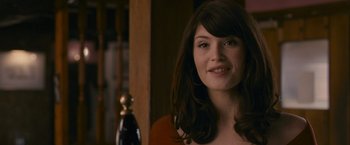 Movie still from “Tamara Drewe” (2010), directed by Stephen Frears – A beautiful young lady smiling for the camera; Close Up shot, Over the shoulder angle