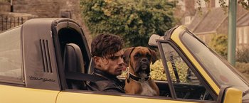 Movie still from “Tamara Drewe” (2010), directed by Stephen Frears – A man and a dog sitting in the back seat of a car; Close Up shot, Over the shoulder angle