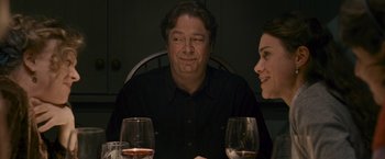 Movie still from “Tamara Drewe” (2010), directed by Stephen Frears – A man sitting at a dinner table with a woman; Close Up shot, Over the shoulder angle