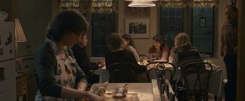 Movie still from “Tamara Drewe” (2010), directed by Stephen Frears – A group of people sitting around a table; Medium shot, Over the shoulder angle