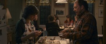 Movie still from “Tamara Drewe” (2010), directed by Stephen Frears – A group of people sitting at a table in a restaurant; Medium shot, Over the shoulder angle
