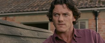 Movie still from “Tamara Drewe” (2010), directed by Stephen Frears – A person wearing a purple shirt; Close Up shot, Over the shoulder angle