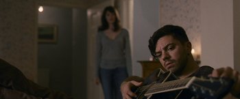 Movie still from “Tamara Drewe” (2010), directed by Stephen Frears – A man and a woman are playing a guitar; Medium shot, Over the shoulder angle