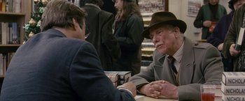 Movie still from “Tamara Drewe” (2010), directed by Stephen Frears – Two men sitting at a table talking to each other; Medium shot, Over the shoulder angle