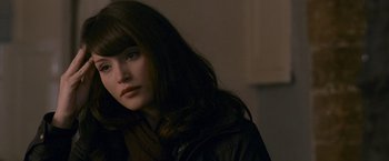Movie still from “Tamara Drewe” (2010), directed by Stephen Frears – A woman with long dark brown hair wearing a brown jacket; Close Up shot, Over the shoulder angle