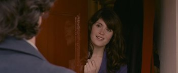 Movie still from “Tamara Drewe” (2010), directed by Stephen Frears – A beautiful young lady standing in front of a door; Close Up shot, Over the shoulder angle