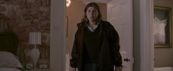 Movie still from “Tamara Drewe” (2010), directed by Stephen Frears – A woman standing in front of a doorway in a room; Medium shot, Low angle