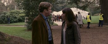 Movie still from “Tamara Drewe” (2010), directed by Stephen Frears – A man and a woman standing next to each other; Medium shot, Over the shoulder angle