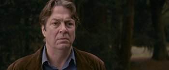 Movie still from “Tamara Drewe” (2010), directed by Stephen Frears – A person wearing a brown jacket; Close Up shot, Over the shoulder angle