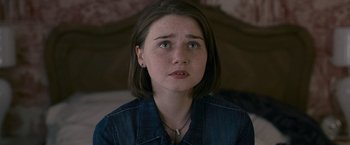 Movie still from “Tamara Drewe” (2010), directed by Stephen Frears – A young woman with short brown hair wearing a denim shirt; Close Up shot, High angle