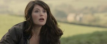 Movie still from “Tamara Drewe” (2010), directed by Stephen Frears – A beautiful woman with long brown hair looking upward; Close Up shot, Over the shoulder angle
