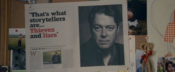 Movie still from “Tamara Drewe” (2010), directed by Stephen Frears – A newspaper with a picture of an older man in black and white; Extreme Close Up shot, Overhead angle