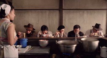 A group of people sitting at a table with plates