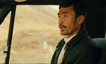 Movie still from “Taste of Cherry” (1997), directed by Abbas Kiarostami – A person in a car; Close Up shot, Over the shoulder angle