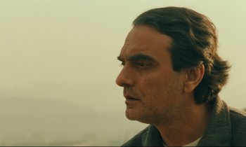 Movie still from “Taste of Cherry” (1997), directed by Abbas Kiarostami – A person with long hair; Close Up shot, Low angle