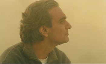 Movie still from “Taste of Cherry” (1997), directed by Abbas Kiarostami – A person with long hair; Close Up shot, Low angle