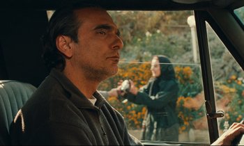 Movie still from “Taste of Cherry” (1997), directed by Abbas Kiarostami – A man and a woman in the back of a car; Medium shot, Over the shoulder angle