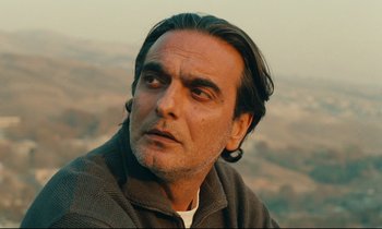 Movie still from “Taste of Cherry” (1997), directed by Abbas Kiarostami – A person with long hair; Close Up shot, Low angle