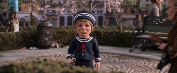 Movie still from “Team America: World Police” (2004), directed by Trey Parker – A doll dressed in a sailor's uniform and holding a camera; Close Up shot, High angle