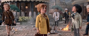 Movie still from “Team America: World Police” (2004), directed by Trey Parker – A woman in a yellow jacket and a man in a suit; Medium shot, Over the shoulder angle