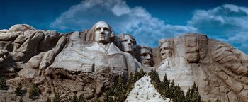 Movie still from “Team America: World Police” (2004), directed by Trey Parker – A group of statues on top of a mountain; Extreme Wide shot, Low angle