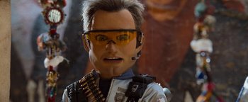 Movie still from “Team America: World Police” (2004), directed by Trey Parker – A man's face wearing goggles and a helmet; Close Up shot, Low angle