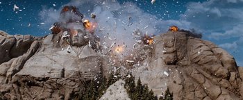 Movie still from “Team America: World Police” (2004), directed by Trey Parker – A group of people that are standing in the dirt; Extreme Wide shot, Low angle
