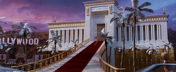 Movie still from “Team America: World Police” (2004), directed by Trey Parker – A red carpet on a staircase leading to a building; Extreme Wide shot, High angle