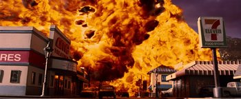 Movie still from “Team America: World Police” (2004), directed by Trey Parker – An image of an explosion in a city street; Extreme Wide shot, Low angle